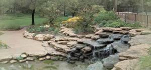 Perennial Garden, Fort Worth Botanic Garden, Fort Worth — A secluded area by a fish pond with a waterfall and a bronze sculpture.