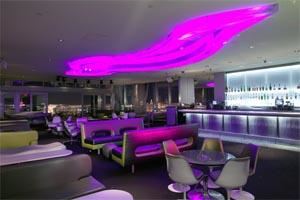 Ghostbar - Las Vegas, Las Vegas — High above the glittering expanse of Las Vegas, the 8,000 square foot Ghostbar is a sultry and sophisticated indoor-outdoor lounge and sky deck on the 55th floor of the Palms Casino Resort. Indoors amid the seductive shadows, the sleek, chic Ghostbar offers ultra lounging luxury among an ethereal color scheme of silver, white, greens and grays. Fourteen foot floor-to-ceiling windows offer a dramatic view of the night sky and the city below; a 30 foot ghost-shaped soffit in the ceiling changes colors as a deejay spins an eclectic music mix. Patrons can luxuriate on the custom, ultra-contemporary lounging furniture, seek privacy in the intimate seating arrangements or VIP lounge, or mingle at the terrazzo bar. Behind the bar, shelves of premium spirits glow with the incandescence cast by back-lit panels of acrylic-encased fabric.