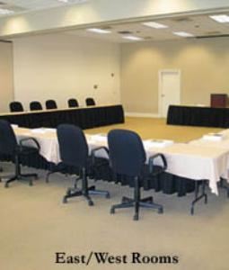 East/ West Room, Tennessee Society Of Certified Public Accountants, Brentwood — Meeting room featuring mounted LCD projector, screen wall and wall AV controls. 8ft skirted tables and black rolling adjustable chairs complement the room. New carpet throughout. Partition wall separates East Room from the West Room. Windows to the fron lawn feature blinds for privacy and light control. Can (on dimmers) and incandescent lighting in the ceiling.