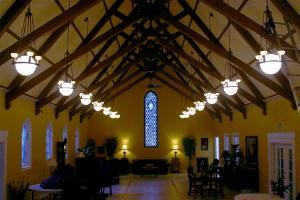 The Chapel, Grand Holiday Ballroom, Olympia — This magnificent room has the charm and architectural details that are reminiscent of European countryside chapels with open beamed ceiling supports that support classic steeply sided open ceilings.

Three of four walls display subtle yet richly colored antique stained glass windows. 

Ceremony occupancy capacities vary from 50 to 200, depending upon seating and ceremony floor layouts. We have many options with which to arrange and divide this space to make it spacious and opulent, or warm and cozy. 

Two side rooms provide entertaining needs and or space for musicians. The side alcove offers a quaint and classic location for available light portraits. Just outside this alcove is your secret garden, also providing a charming tiny portrait opportunity location.