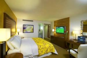 Hilton Waikiki Prince Kuhio, Honolulu — This spacious room includes a kingsize bed, beautifully decorated with clean lines and exotic wood furnishings. Our Technology-advanced guestrooms feature the GuestLinkTM system that includes a flat screen 42'' Plasma HDTV multi-media monitor with premium channels. Standard amenities include refrigerator, laptop safe, 2 two-line phones with voicemail, individually controlled air-conditioning, coffee maker with complimentary regular and decaffeinated coffee and tea, iron, ironing board, and hair dryer.