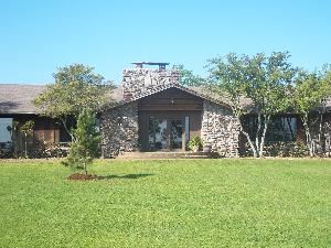 Valley View Lodge, Ozark Conference Center, Solgohachia — Valley View Lodge lives up to its name, featuring expansive rooms with walls of windows which frame the beautiful view.  In addition, a lovely grape arbor and observation deck offer views of the magnificent sunset.  The three guest rooms can house a group of 24. The meeting room, highlighted by a central stone fireplace, accommodates up to 75 people. This lodge contains a large kitchen and dining space with basic kitchen and dinnerware supplies that can be used to provide your own meals if you desire.
