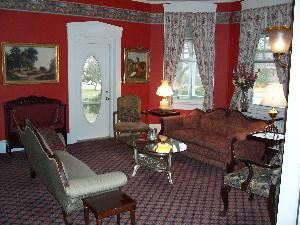 Parlor, Cambridge House Bed and Breakfast, Cambridge — The parlor has three settees and two chairs that can comfortably seat up to eight people. This room is nice for those who prefer a less formal setting than a conference room style meeting. The parlor also makes a great break out room.