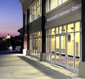 Side view of the BancorpSouth Conference Center at dusk. The old Tupelo Courthouse is in the background.
