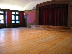 Meeting Hall, First Church In Cambridge, Cambridge — Margaret Jewett Hall, the church’s auditorium, seats 200 with a small stage for performance. Painted in a rich burnt umber color, the space includes hardwood floors, an acoustical ceiling, a sound system and a bank of windows overlooking Mason street. With the adjacent library, this handicapped-accessible space is ideal for receptions, lectures, small concerts, and meetings.