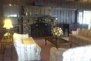 The Great Room, Far-A-Way Archdiocesan Retreat House, Longbranch — The great room is a large lodge type room that can be arranged for conferences and workshops. It has a large fireplace and a big screen TV in place for guest use.