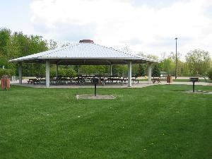 Open air pavilion with ten picnic tables.  Playground and volleyball courts adjacent to pavilion.  Parking is available off Manhattan Road.