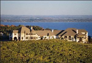 Chateau Chantal is a 65-acre estate located on the Old Mission Peninsula in one of the most scenic
areas of the Great Lakes. It is a unique destination that combines vineyards and winery, a bed &
breakfast, winding roads, fresh air and kind company. All of which serve to create a retreat into the
Old World.
The bed & breakfast at Chantal offers an ambiance unlike any other in the Midwest. Our eight suites, two standard
units, and executive apartment each include a private bath, modern amenities, the coziness of a secluded retreat,
breathtaking views, a full breakfast, and access to the Chateau's Great Room, fireplace and tasting bar. Our 2,000
square foot hospitality room offers views of Grand Traverse Bay and is the perfect setting for an executive retreat,
planning session, or small meeting. There is flexibility to create the meeting environment you require—from
casual fireside seating to formal classroom style presentations.
