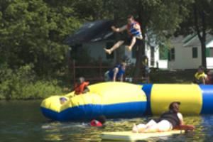 Waterfront, Camp Scully, Wynantskill — Our beach borders Snyder's Lake. A giant water trampoline and launcher is very popular. Sailing, kayaking and canoeing are available from our dock. Beach parties and BBQ's can be held.