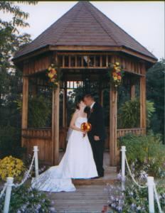Cheers Reception Building, Cheers Chalet, Lancaster — The outdoor ceremony area shown here features a gazebo and nearby water garden set among the wooded backdrop.  Building features a large covered patio and indoor event facility dressed elegantly for your event.