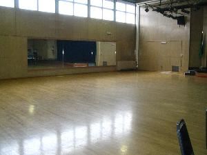 Auditorium with wood floor and access to a full kitchen.  The maximum occupancy is 175 standing / 100 at tables.