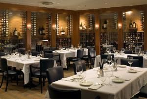 The Wine Cellar, Legal Sea Foods, Park Square, Boston — Down the spiral staircase by a flowing waterfall, you will discover a unique
private dining area unlike any other location found in Boston. Elegant and
richly decorated, the Wine Cellar consists of four private rooms along with a
Wine Bar & Cocktail Lounge. Glass vaults showcase our 10,000-bottle collection
of rare and fine wines. Warm cherrywood paneling and mahogany tables
underscore the feeling of luxury and comfort, while sconces cast a soft glow
on stacked-stone walls.