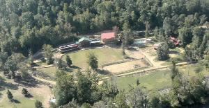 French Broad Outpost Ranch, Del Rio — An aerial photograph of the main part of our ranch. To the left is the 4 lodge rooms, the lodge is in the center with restaurant and game room, the Hotel is to the right of the lodge with 7 rooms and saloon/meeting room, and the pool is further to the right.