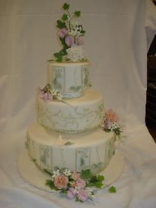 Exclusive custom designed wedding cake.  Fondant panels with hand-fashioned floral sugar art.