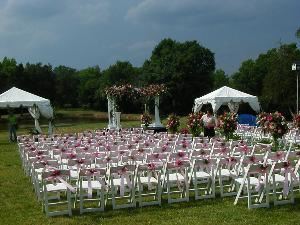 Outdoor Wedding Area, Kilburnie The Inn At Craig Farm, Lancaster — Chairs decorated with ribbons and fresh flowers create an unforgetable ambiance.