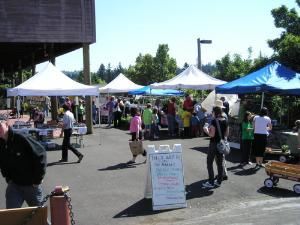Parking Lot, Multnomah Arts Center, Portland — The Multnomah Village Farmers' Market is hosted by the Multnomah Arts Center and sponsored by Multnomah Village Business Association every Thursday from 3:30 pm to 7:30 pm June through September.