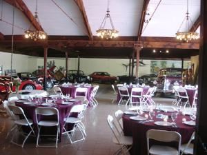 Museum Rental Space, Sarasota Classic Car Museum, Sarasota — Party set up in our museum amongst our classic car display.  Note the vaulted ceiling, chandeliers and wooden beams!  This space can be dressed up for a black tie affair or a redneck ball!  Everyone has fun here!
