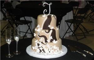 Art Eats Bakery, Greenville — Three tier fondant wedding cake with sugar butterflies and chocolate swirls.
We specialize in creative artistic designed cakes that are as delicious as they look for any special day. A wedding, birthday, anniversary, new baby, ect. should be celebrated in style. Cakes can be sculpted into any shape you desire. Serving Greenville, Simpsonville, Mauldin, Greer and surrounding Upstate South Carolina areas.  email at sales@arteats.com 
  All cakes and icings are scratch made with the finest fresh ingredients available. Real butter, cream cheese, eggs and fine chocolates make our confections melt in your mouth delicious.