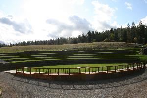 Coeur d'Alene Meadows Amphitheatre, Settlers Creek, Coeur d'Alene — 14,500 sq.ft. eight level all grass amphitheatre intuitively carved from native pastures adjacent to authentic farm setting.  Venue features a 3,200 sq.ft. main stage/assembly area encompassed by radius stained concrete and oxidized steel railing and terrace walls made of natural river rock and rustic steel fabric, 5 ft. diameter all steel fire fit and a naturally bedded 50 ton volcanic rock boulder.

Amphitheatre is uniquely designed as a natural extension of the surrounding rolling pastures and esthetically compliment the surrounding authentic farm architecture while providing superior viewing from all terraces specifically design to host as many as 500 guests for formal dining.