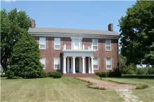Agnus Dei Farm, LLC, Lexington — Entrance of Historic Home.  A brick walkway and portico with lawn in front of house.