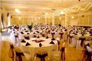 Ballroom, The Spokane Masonic Center, Spokane — The Ball Room, decorated in Roses and Teals is finished with panels between a plain dado and frieze.  The polished maple floor for dancing is spring-loaded and provides the best dancing surface in the city.  The grandeur of this room is in its size. The stage is 28 feet wide by 8 feet deep.  The overall floor plan is more than 70 feet deep and 92 feet wide with a ceiling height of 18 feet.