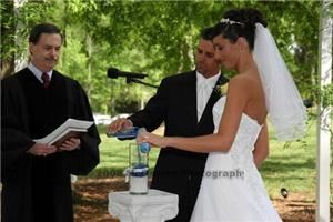 WEDDING OFFICIANTS ATLANTA, Atlanta — REVEREND THOMAS JOHNSON PERFORMING UNITY CANDLE CEREMONY FOR UNIVERSITY OF GEORGIA ALL-AMERICAN BOB SAMSON AND WIFE IN OUTDOOR CEREMONY AT THE UGA CHAPEL.