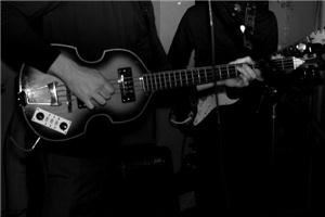 Beatles For Sale, Atlanta — The Hofner Bass is one of the most recognizable features of Sir Paul McCartney's signature bass style.  Here we can see him playing right handed (one of the only photos ever captured of him playing in this manner).