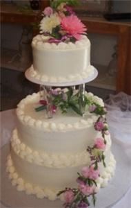 Truffle Trolley, Peoria — All of our cakes are created fresh the day before your function, they are NEVER frozen.  Our cakes are decorated by award winning Executive Pastry Chef Ted Anderson.  Floral arrangements are professionally created by Barbara, our on staff florist.  In addition to our fabulous cakes, we also have great truffle wedding and party favors.