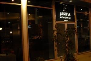 Juniper kitchen and WIne Bar, Ottawa — Imagine the beauty of this contemporary and distinctive dinning room: smoky window walls wrapping around three sides of the dining room, revealing the colours of flowers, the sparkle of china and silver, the flickering of candles. Imagine your guests entering through the frosted front door, entering into an intimate warm space that immediately suggests that this day, this dinner, this celebration will be extraordinary.