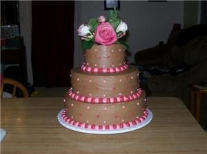 Kreations by Krystal, Dayton — Maries wedding cake.Vanilla cake with whipped french vanilla filling and chocolate buttercream.Vanilla buttercream pearls in fuschia and baby pink.Flower bouquet topper.