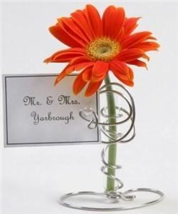 The Funky Shack Art Studio, Atlanta — This is just one of many items that I design and create. This is a mini bud vase card holder that serves as a place card holder, table number holder, or wedding favor. It is made with shiney silver wire twisted around a mini glass bud vase perfectly to hold a card.