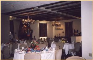 Thunderbird Room, Bishop's Lodge - Ranch, Resort & Spa, Santa Fe — A nostalgic setting featuring a colorfully hand-painted bar, copper-hooded fireplace, and tin chandeliers