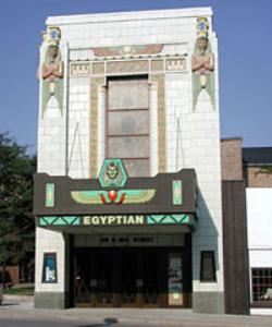 The Egyptian Theatre, Dekalb — Built in 1928-1929, the Egyptian Theatre was created during a time when the entire country was caught up in the mystery of the discovery of King "Tut"'s Tomb. The entire country was infatuated with Egyptian clothing, parties, and young Hollywood was turning out mummy movies!! 
The architect, Elmer F. Behrns, had studied and loved Egyptology. But instead of throwing together hieroglyphics, falcon wings, and other Egyptian motifs, Mr. Behrns designed this theater with one central theme, that of Ramses ll, one of the Egyptian pharoahs.