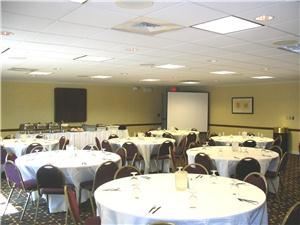 Windswept Room, Residence Inn Frederick, Frederick — In the photograph, the Monocacy Room is set up for a banquet. The room can accommodation up to 56 people at round tables, 54 people classroom style and 70 people theater style. This room is perfect for a range of events from a baby shower to a business meeting!