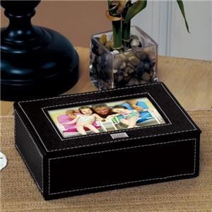 Planning Pad, Fort Lauderdale — Our Photo Keepsake Box is just the right balance of casual style and contemporary elegance. Fashioned in a black leatherette finish with white topstitching, this keepsake box is gently lined with black velvet and easily holds 4x6 photos or your most treasured keepsakes. Sure to match any decor, this photo box is an attractive way to accent any room!

Details: 
Size: Photo box measures 6 3/4" by 5 1/4" by 2 1/4 inches with a 4 3/8" by 2 5/8 inches outer photo slot. 
Materials: Black leatherette finish and velvet

Engraving Options: 
The Photo Keepsake Box may be engraved with up to three initials on a silver plate or stamped in silver ink at No Additional Cost. Silver plate has adhesive backing for placement of your choice upon arrival.