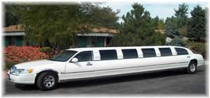 Elegant Image Limousine Service, Elyria — This is a classic super stretched white limousine, perfect for an elegant wedding.  Wrap-around seating available for 13 with a fireplace, fiberoptic lighting and more.