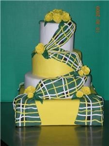 Lovely Little Cake Shop, Mesa — I have noticed that there is not too many wedding cakes with an Irish theme. I have created a four tier cake both square and round shapes. I have an Irish Tartan (kilt)draped across all layers of cake with yellow roses as accents.