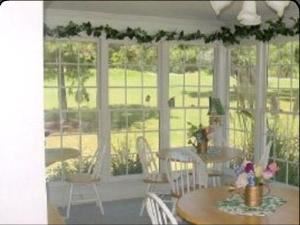 Sunroom, B&B Country Garden Inn, Apex — Enjoy your breakfast in the sunroom while overlooking the grounds of the inn. The sunroom makes a great place to hold company events, bridal showers & more!
