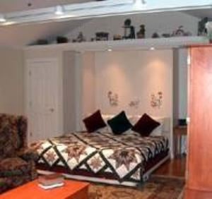 Suite 50, Country Inn at Camden/Rockport, Rockport — Large Suite with living and sleeping area combined 
King size bed with two wingback recliners for your comfort 
Luxurious Jacuzzi tub for two 
Television/VCR 
Wet bar with refrigerator and microwave oven