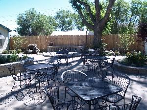 Dee's Bakery Courtyard Cafe and Venue, Reno — Full patio with water feature and fire pit. Three large light trees and lighted patio leading into a full dinning room.