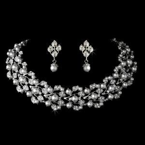 Portland's Treasure Chest, Portland — A striking pearl necklace and earring set showcasing a silver setting and delicate leaf design laden with gorgeous white faux pearls and encrusted with clear crystals. Matching earrings complete the set. This beautiful bridal set makes the perfect accessory for every special occasion.

Size: Necklace: (L) 24'', (Diameter) 4'', (Extender) 2.5'', Earrings: (H) 1.25'', (W).5''
  
This jewelry set generally mails out in 1-3 days from the warehouse
