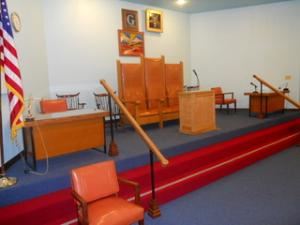 Meeting Room, Castro Valley Masonic Center, Castro Valley — The huge carpeted Meeting Room dimensions are 45 ft X 66 ft, with adequate lighting and easy access to the Entry.  Leather bench seating, on the sides of the room, accomodates 125 people comfortably.  Additional seating is available, with folding chairs placed in the center of the room, to the room maximum of 315 people.
