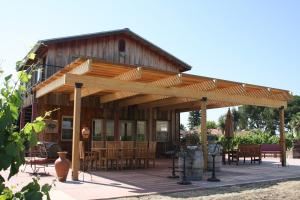 Cedar View Winery, Sanger — Cedar View Winery's patio is surrounded by its estate vineyard. The patio faces east and has views of the local and Sierra Nevada mountains. The patio can seat up to 90 people for a dinner. The winery's indoor cellar room can seat approximately 50 people.