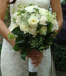 Duffy's Flowers and Plants, Solon — white roses with bluepleurum and other greens