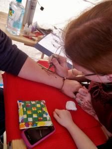 Hennatopia, Hillsboro — Veronica Lacquement, artist and owner of Hennatopia, doing henna at Carnival Days 2012.