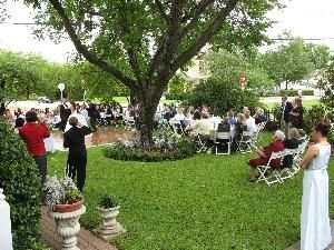 East Front Yard, The Carpenter House, Plano — Shaded by towering trees, with landscaped flower beds accented by antique roses and evergreen shrubs, the east front yard can be an especially unique ceremony site or provide table seating for up to 150.