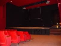 Wells Fargo Auditorium, National Hispanic Cultural Center, Albuquerque — The 97-seat Wells Fargo Auditorium is ideal for lectures, computer presentations or any type of meeting requiring audio and visual capabilities. This intimate theatre space is uniquely lit, with black stage and backstage area and dark red walls and seats.