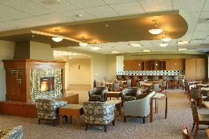 Lounge, CenterPlace Regional Event Center, Spokane — A cozy fireplace welcomes you as you walk in this luxurious room. A perfect spot for receptions, dances or other events up to 150 people. Amenities include: an upscale bar, a lounge area and an intimate seating area.  Beautiful views from the dance floor and outside deck only add to the elegance of this room.