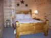 Luxury Blue Ridge Cabin Accommodations, Blue Ridge — Third Bedroom and Bath is located on the lower level (same as Game Room) and features a custom made rustic Queen Bed with Log dressers.