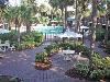 Ramada Gateway, Kissimmee — Shaded patio area with tables surround the pools.